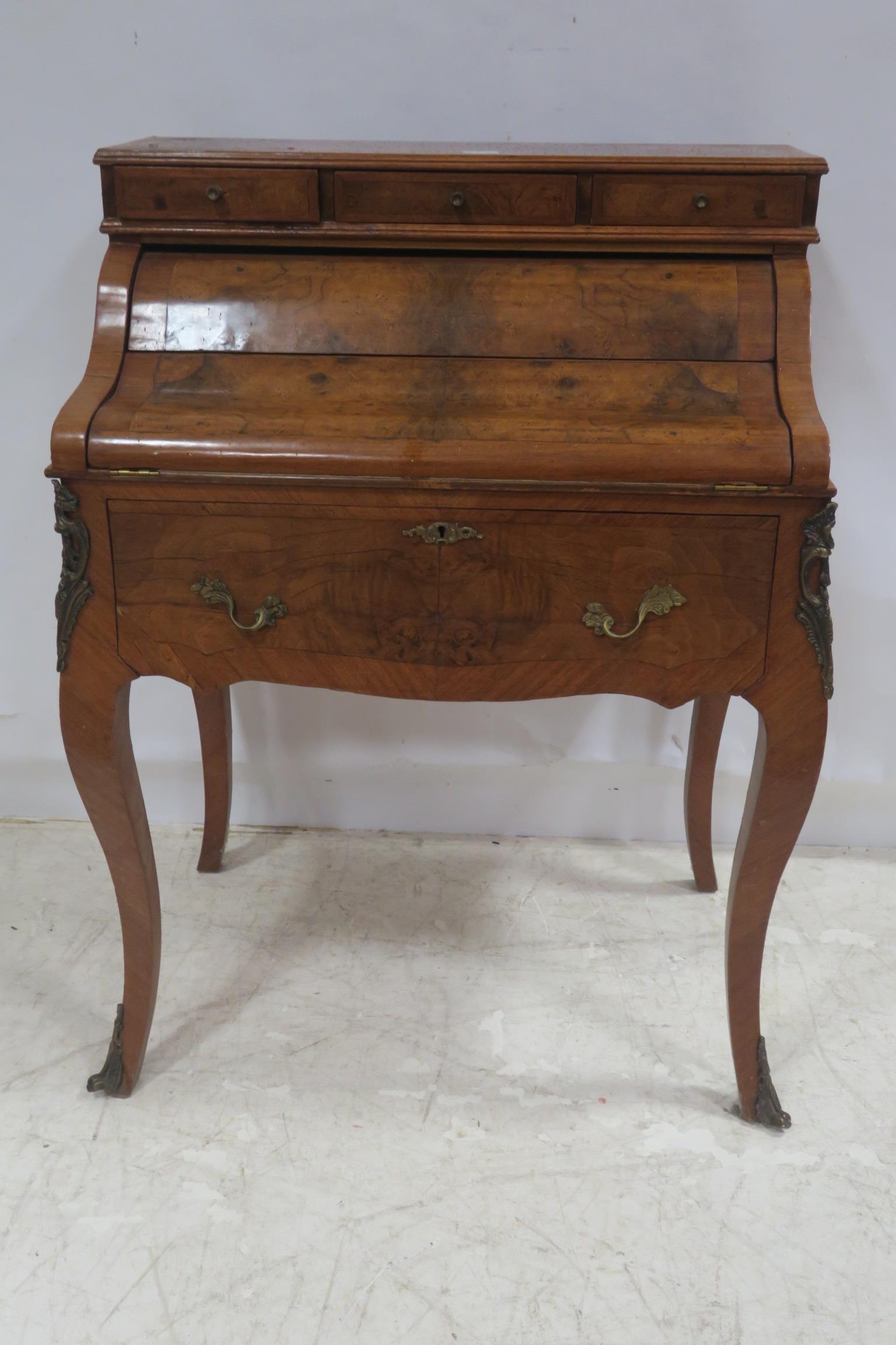 A CONTINENTAL BURR WALNUT AND GILT BRASS MOUNTED DESK the superstructure containing three short