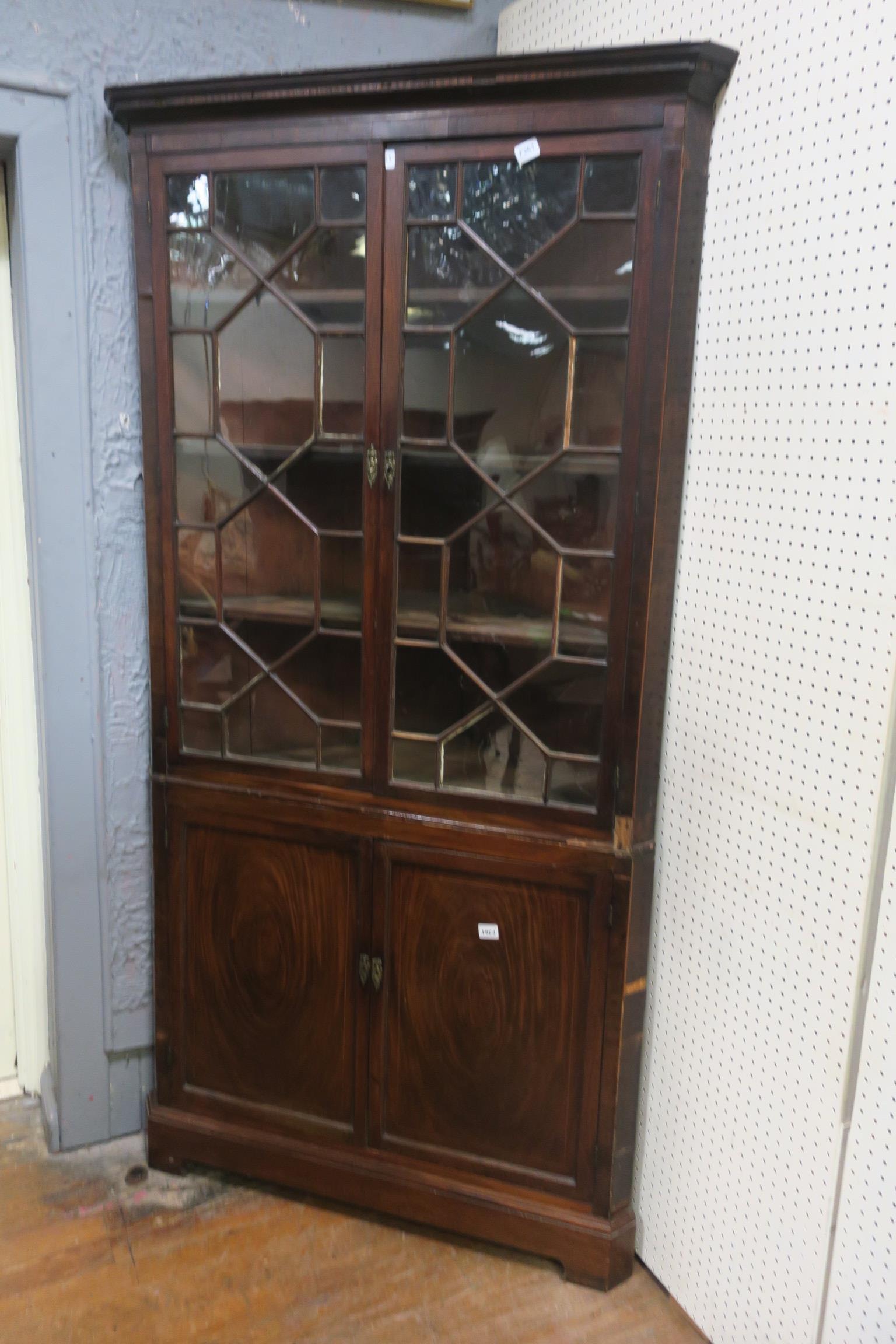 A GOOD GEORGIAN MAHOGANY CORNER CABINET the moulded cornice above a pair of astragal glazed doors