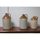 THREE GLAZED EARTHENWARE WHISKY JARS inscribed Murray & Company Glasgow numbered 2 3 and 4