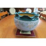 AN ART DECO GLAZED POTTERY JARDINIERE the light blue and turquoise ground with stylized flower