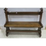 A GOOD 19TH CENTURY OAK PEW the planked seat and top rail between carved standard end supports on