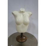 A FEMALE BUST raised on a baluster column with circular spreading foot 63cm x 42cm