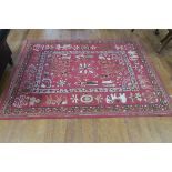 A WOOL RUG the light pink ground decorated with animals stylized flower heads and foliage 224cm x