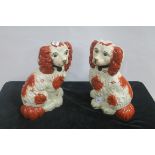 A PAIR OF STAFFORDSHIRE STYLE FIGURES each modelled as a dog shown seated 30cm (h)