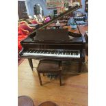 A CHALLEN MAHOGANY CASE BABY GRAND PIANO raised on square tapering legs with brass caps and castors