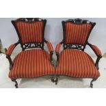 A PAIR OF 19TH CENTURY CARVED MAHOGANY AND UPHOLSTERED ARM CHAIRS with shell cresting above an