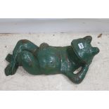 A CAST IRON FIGURE modelled as a frog shown recumbent