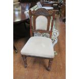 A 19TH CENTURY CARVED MAHOGANY SIDE CHAIR the arched top rail above an upholstered panel and seat