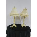 A PAIR OF CONTINENTAL WHITE PAINTED TABLE LAMPS each of baluster form on scrolled supports with