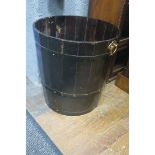 A STAINED WOOD AND METAL BOUND FUEL BIN of cylindrical tapering form with brass carry handles 50cm