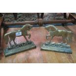 A PAIR OF 19th CENTURY BRASS DOOR STOPS each modelled as a horse shown standing on a rectangular