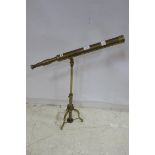 A BRASS TELESCOPE on adjustable stand with tripod base 116cm x 76cm