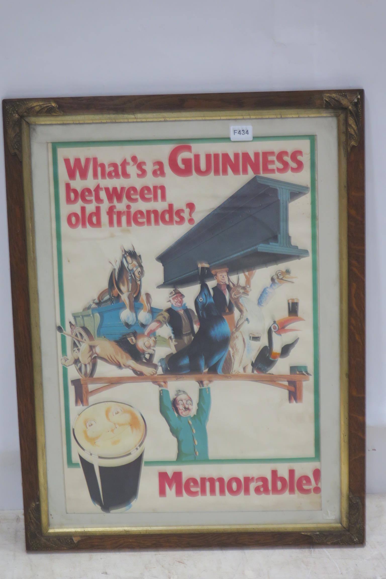 A GUINNESS ADVERTISING SIGN inscribed What's a Guinness Between Old Friends? Memorable! in oak and