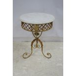 A WROUGHT IRON AND MARBLE TOP OCCASIONAL TABLE of circular outline with pierced rim on scroll