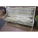 A 19TH CENTURY CAST IRON AND PINE GARDEN BENCH with slatted back and seat with pierced scroll arms