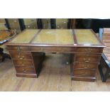 A GEORGIAN DESIGN MAHOGANY PEDESTAL DESK the rectangular top with tooled leather inset above three