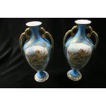 A PAIR OF CONTINENTAL PORCELAIN VASES each of baluster form the turquoise white and gilt ground
