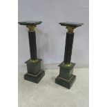 A PAIR OF GREEN VEINED MARBLE COLUMNS each with a square top above a cluster pillar with Corinthian