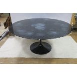 A BLACK MARBLE TABLE of circular outline raised on an ebonised column with spreading foot 72cm (h)