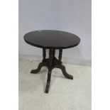 A MAHOGANY OCCASIONAL TABLE of circular outline raised on ring turned supports and platform base