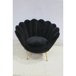 A RETRO BLACK UPHOLSTERED FAN BACK TUB SHAPED CHAIR with upholstered seat on brass tapering legs