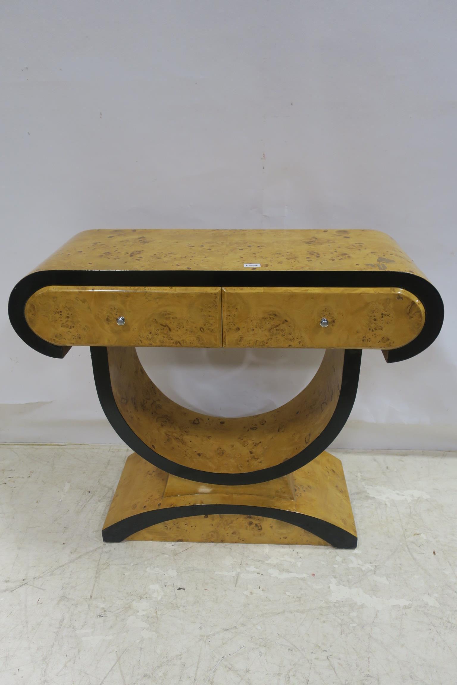 AN ART DECO DESIGN WALNUT CONSOLE TABLE the shaped top above two frieze drawers raised on a