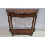 A THEODORE ALEXANDER WALNUT SIDE TABLE of demilune outline the shaped top with frieze drawer raised