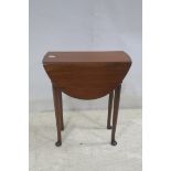 A GEORGIAN DESIGN MAHOGANY DROP LEAF TABLE the oval hinged top raised on moulded legs with pad feet