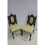 A FINE PAIR OF JACOBEAN DESIGN CARVED ROSEWOOD SIDE CHAIRS each with an oval upholstered panel and