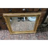 A GILT FRAME MIRROR the rectangular plate within a shell and foliate moulded frame 60cm x 76cm