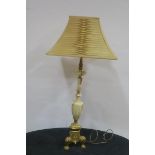 AN ALABASTER AND GILT BRASS TABLE LAMP of urn form raised on triform base with foliate decoration