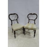 A SET OF FOUR 19TH CENTURY MAHOGANY DINING CHAIRS each with a carved top rail and splat above an