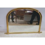 A VICTORIAN DESIGNED GILTWOOD OVERMANTLE MIRROR the rectangular arch plate within a moulded frame