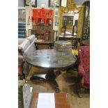 A 19TH CENTURY ROSEWOOD AND MAHOGANY POD TABLE of circular outline the shaped top above a faceted