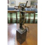 AFTER MILO A BRONZE FIGURE modelled as a semi clad female shown standing with arm raised draped
