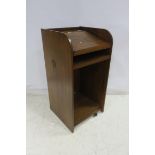 A CHERRYWOOD LECTERN with sliding shelf above an open compartment with panelled sides 120cm x 60cm