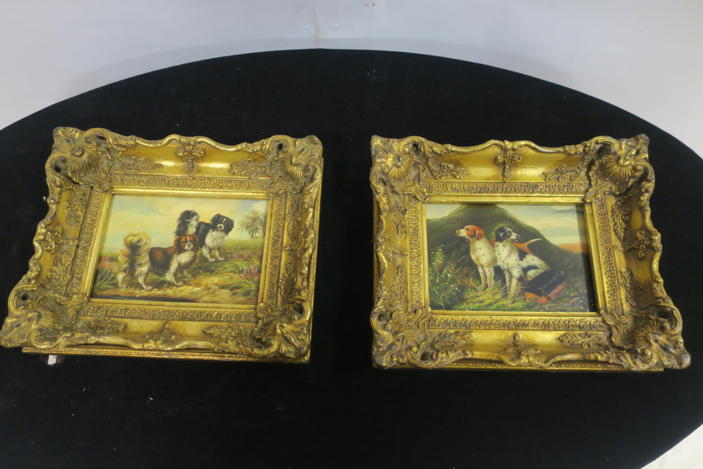 DOGS IN A LANDSCAPE Oil on panel A pair in ornate gilt frames 22cm x 27cm