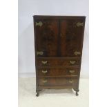 A GEORGIAN DESIGN MAHOGANY TALL BOY of rectangular outline with cupboards and three long drawers