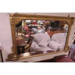 A 19TH CENTURY GILT FRAMED OVER MANTLE MIRROR the rectangular plate within a reeded moulded frame