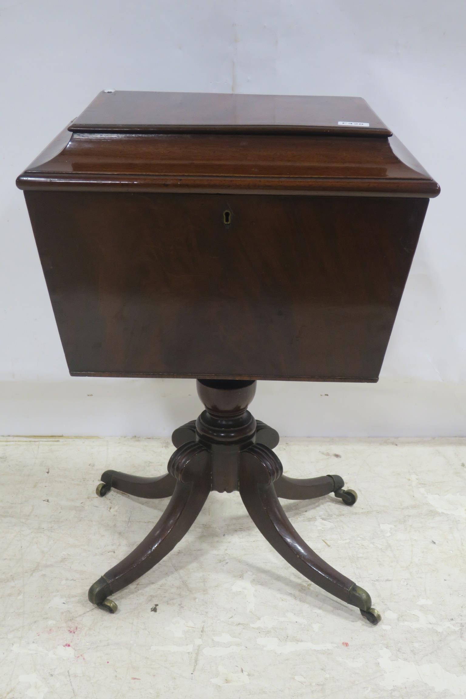 A GEORGIAN MAHOGANY AND ROSEWOOD CROSS BANDED CELLARET the hinged lid containing compartments above