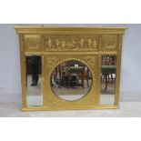 A GILTWOOD AND GESSO COMPARTMENTED OVER MANTLE MIRROR the frieze moulded in leaf with frolicking