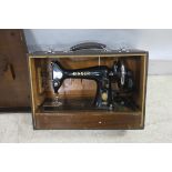 A VINTAGE PORTABLE SINGER SEWING MACHINE in carrying case