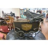 A VINTAGE CHILD'S PRAM with canvas folding hood on spoke wheels 98cm (h) x 120cm (w) x 47cm (d)