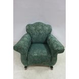A MAHOGANY AND UPHOLSTERED EASY CHAIR the shaped back with scroll over arms on moulded legs and