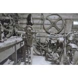 A GLAZED PHOTOGRAPH depicting Harley Davidson motorbike in workshop 80cm x 120cm