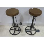 A PAIR OF RETRO BLACK METAL BIKE STOOLS each with circular upholstered seat 75cm (h)