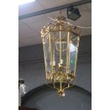 A FINE CONTINENTAL GILT BRASS AND GLAZED FOUR LIGHT LANTERN of octagonal tapering form with