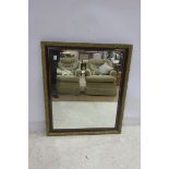 A STAINED WOOD AND GILT FRAMED MIRROR the rectangular plate within a moulded frame 103cm x 88cm