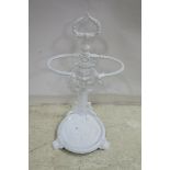 A VICTORIAN DESIGN CAST IRON STICK STAND with figural cast back plate and circular drip tray