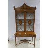 A VERY FINE SATINWOOD AND POLYCHROME DISPLAY CABINET the shaped pediment with urn finials above a